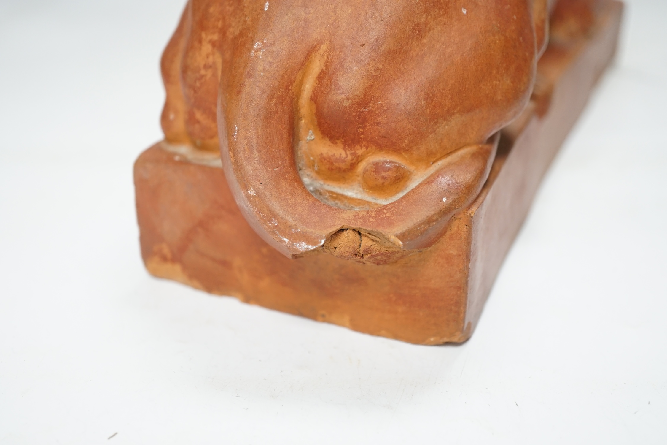 After Antonio Canova (1757-1822), a terracotta figure of a recumbent lion, 33cm. Condition - poor to fair